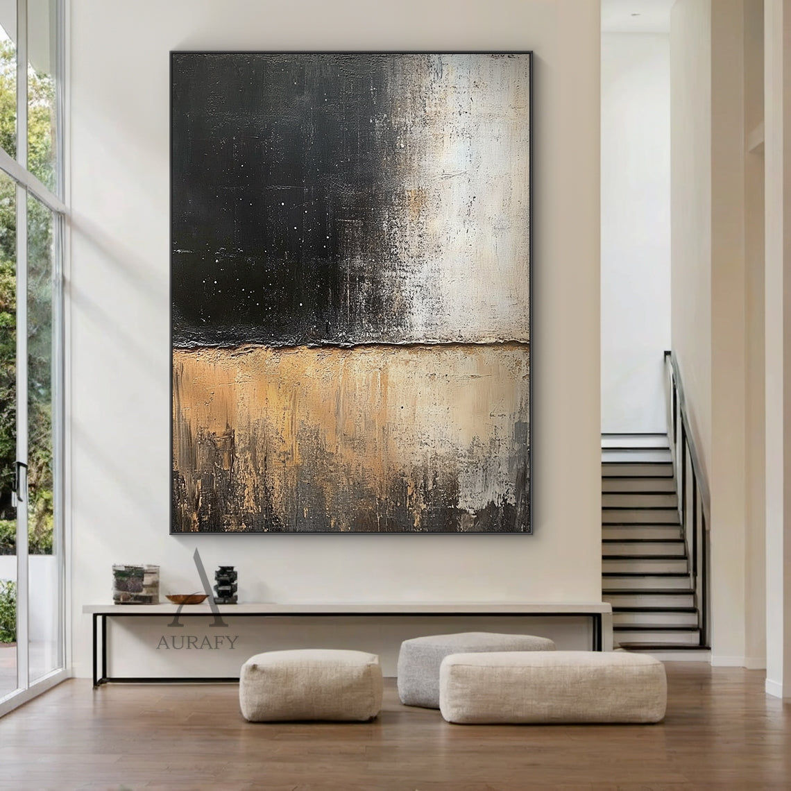 General abstract impasto canvas wall artwork AURA405, displayed as hanging decor in a minimalist Japandi living scene above a low-profile solid oak side cabinet against a plain off-white wall: it retains the iconic horizontally split textured composition, upper zone with thick textured deep black paint scattered with tiny white star-like specks gradually fading to muted light beige, lower zone with layered earthy beige, warm tan and dark brown tones with vertical dragged brushstrokes presenting distinct ero
