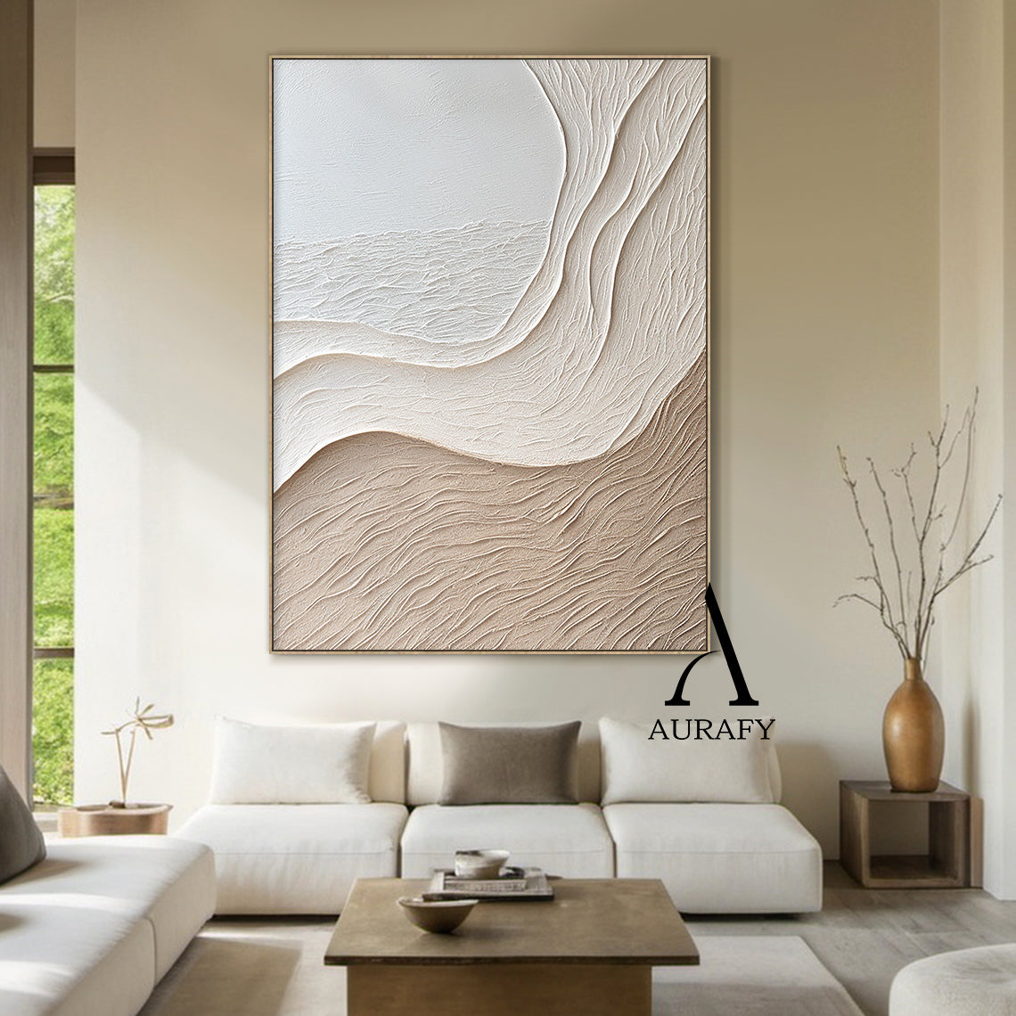 Aurafy AURA539 minimalist beige wall art, plaster textured high relief abstract canvas artwork. Displays the piece hung above a low oak sideboard against a soft white wall, its monochromatic soft gradient from cool off-white to warm light khaki beige blends seamlessly with neutral linen and jute decor accents, the organic undulating flowing curves inspired by wind-swept sand dunes and gentle shore slopes cast subtle soft shadows under ambient light, highlighting the raised impasto surface with fine linear s
