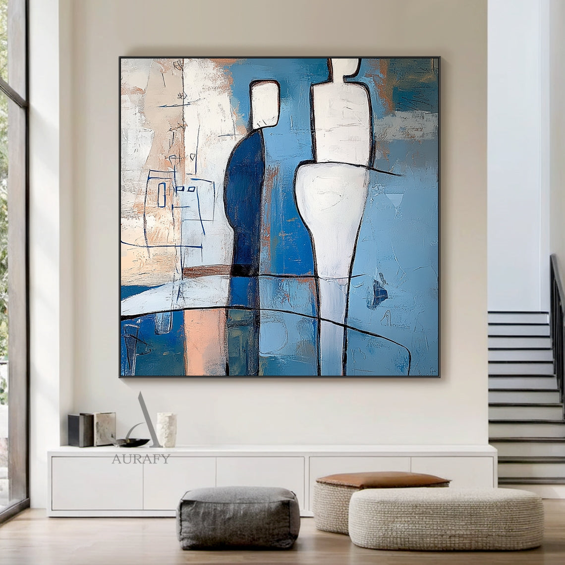 Blue abstract wall art (AURA648) with tactile layered brushstrokes and bold black outlined geometric humanoid forms. Features two central contrasting figures: a deep navy blocky figure with white head, a taller fluid curved white figure, plus a delicate thin blue line sketch humanoid on the left. Painterly background in sky blue, azure, navy tones with subtle warm beige and cream accents, presents calm introspective modern abstract aesthetic perfect for contemporary home decor.