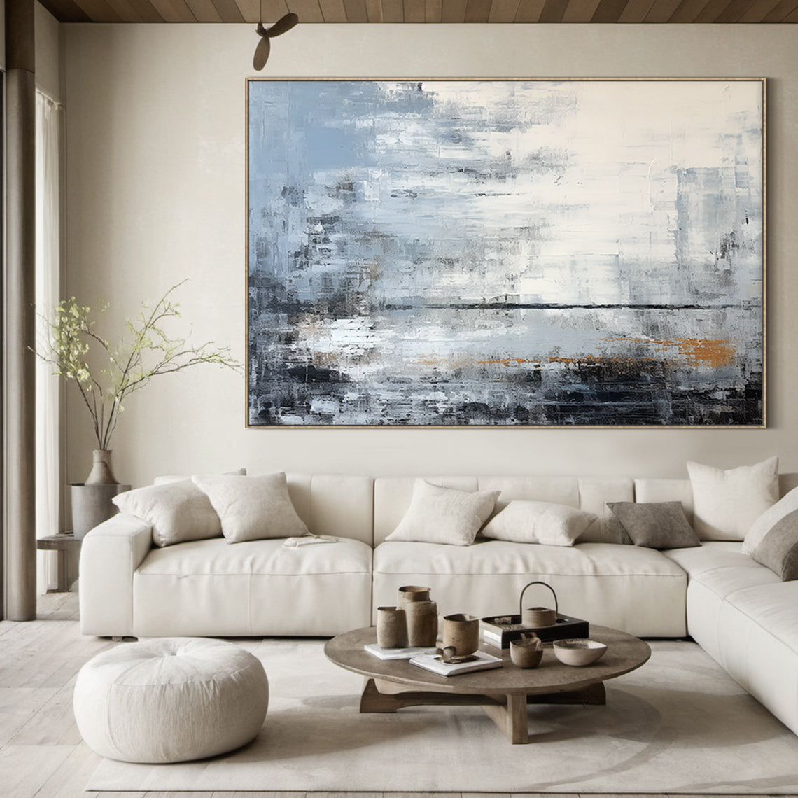 Modern abstract blue geometric wall art with textured brushwork: shades of gray-blue, cobalt, white, gray, black, and subtle warm orange accents. Features abstract blocks and thick impasto texture. Displayed above a light gray linen sofa in a modern living room with a wooden coffee table and potted greenery—perfect focal point for minimalist, Nordic, or modern home decor. Ready-to-hang with a sleek black aluminum frame and premium waterproof canvas.