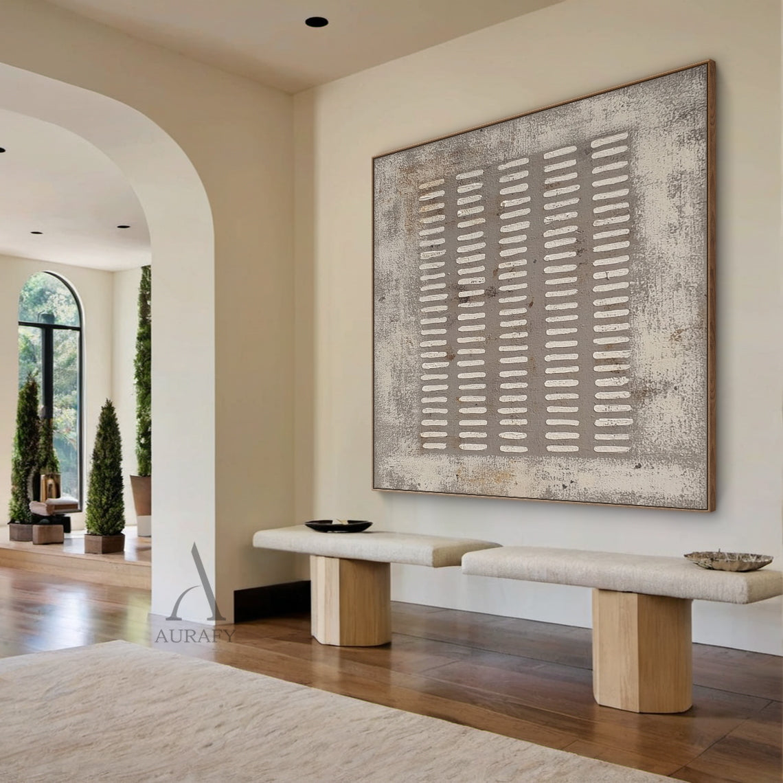 Square gray abstract plaster textured wall art (AURA628) real home scene display, the artwork with 5 vertical columns of irregular handcrafted white short rectangular lines on muted distressed gray base is presented in a different actual home space matching, this rough weathered canvas-like textured wabi-sabi modern organic minimalist piece blends naturally with the surrounding interior furnishings, providing intuitive reference for Japandi, neutral minimalist home decor and soft outfit selection.