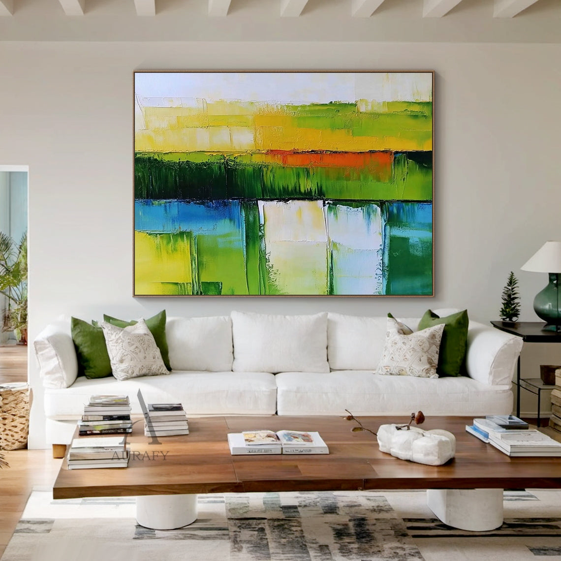 Horizontal green blue abstract impasto canvas wall art cozy living space display (AURA405), crafted with thick knife-painted texture for 3D tactile surface. Features layered horizontal color blocks in shades of green (lime, deep forest green), blue (soft sky blue, rich teal), accented with warm yellow, orange and creamy white blocks. The non-figurative abstract artwork evoking natural scenery of sunlit meadows and calm coastal waterways is presented in a real daily living interior to show its perfect matchi