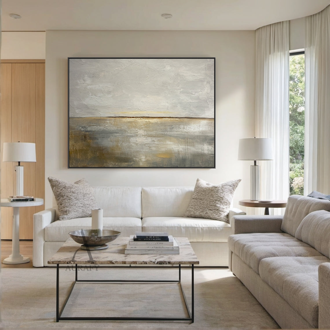 General abstract Japandi style palette knife impasto canvas wall art AURA625, displayed hung on the matte warm white plaster wall above a low-profile light gray fabric sofa in the lifestyle shot, the painting's soft misty gray upper and warm dawn beige lower tones blend harmoniously with surrounding light oak coffee table, frosted glass tableware and creamy wool throw pillows, the thick raised impasto strokes present distinct 3D layering under warm scattered floor lamp light, providing practical decor refer
