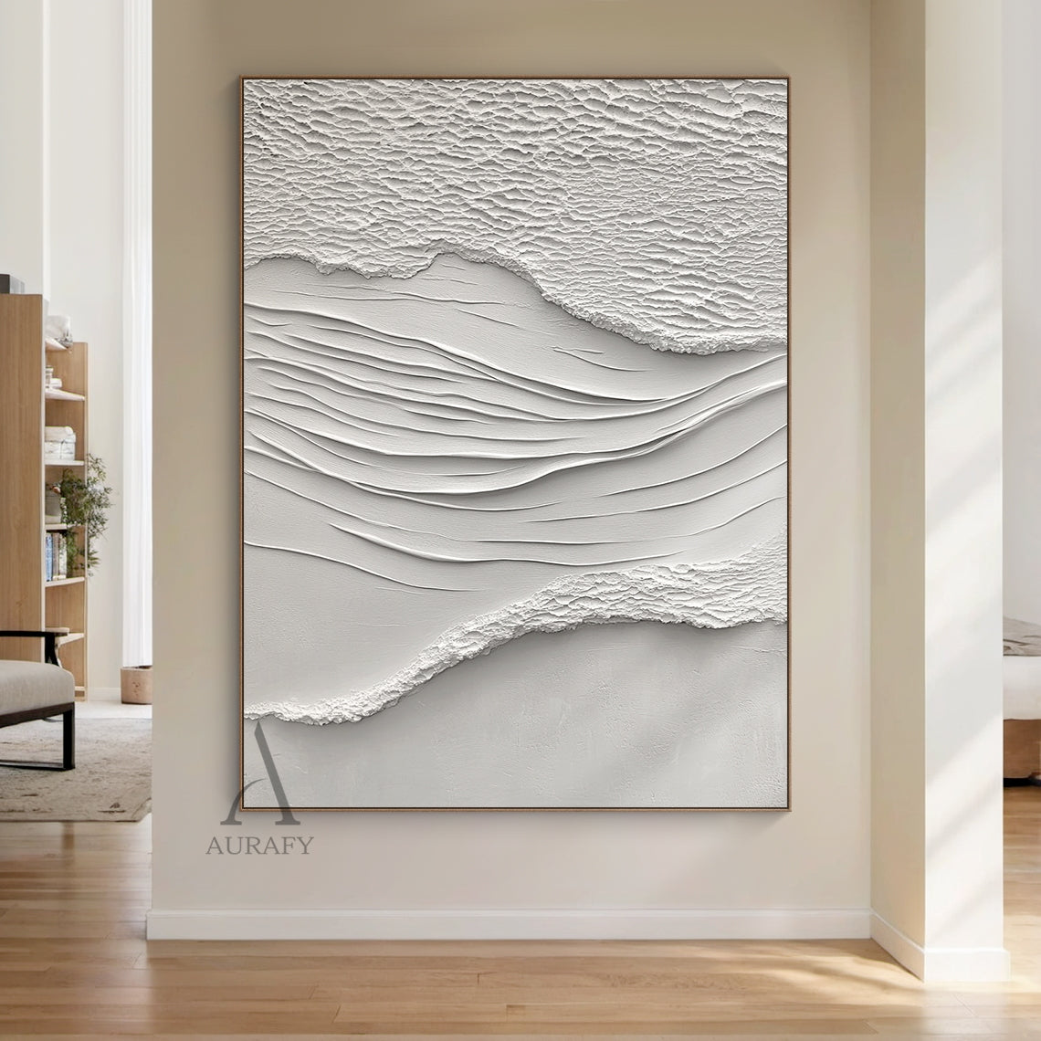 White Sea Textured High-Relief Plaster Artwork (AURA443): Abstract ocean-inspired piece with rough foam/sand-like textured edges, smooth flowing wave lines, monochromatic ivory-off white palette. Tactile 3D surface ideal for serene bedroom headboard walls, minimalist entryway accents, cozy reading nook centerpieces, or bright sunlit kitchen backsplash areas. Complements neutral decor and natural light.