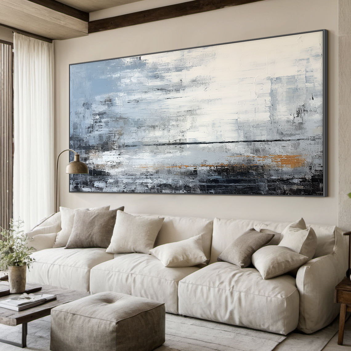 Modern abstract blue geometric wall art with textured brushwork: shades of gray-blue, cobalt, white, gray, black, and subtle warm orange accents. Features horizontal horizon line, thick impasto texture, abstract blocks. Displayed above white sectional sofa in modern living room—ideal focal point for minimalist, nordic, or modern home decor. Ready-to-hang with sleek black aluminum frame, premium waterproof canvas.