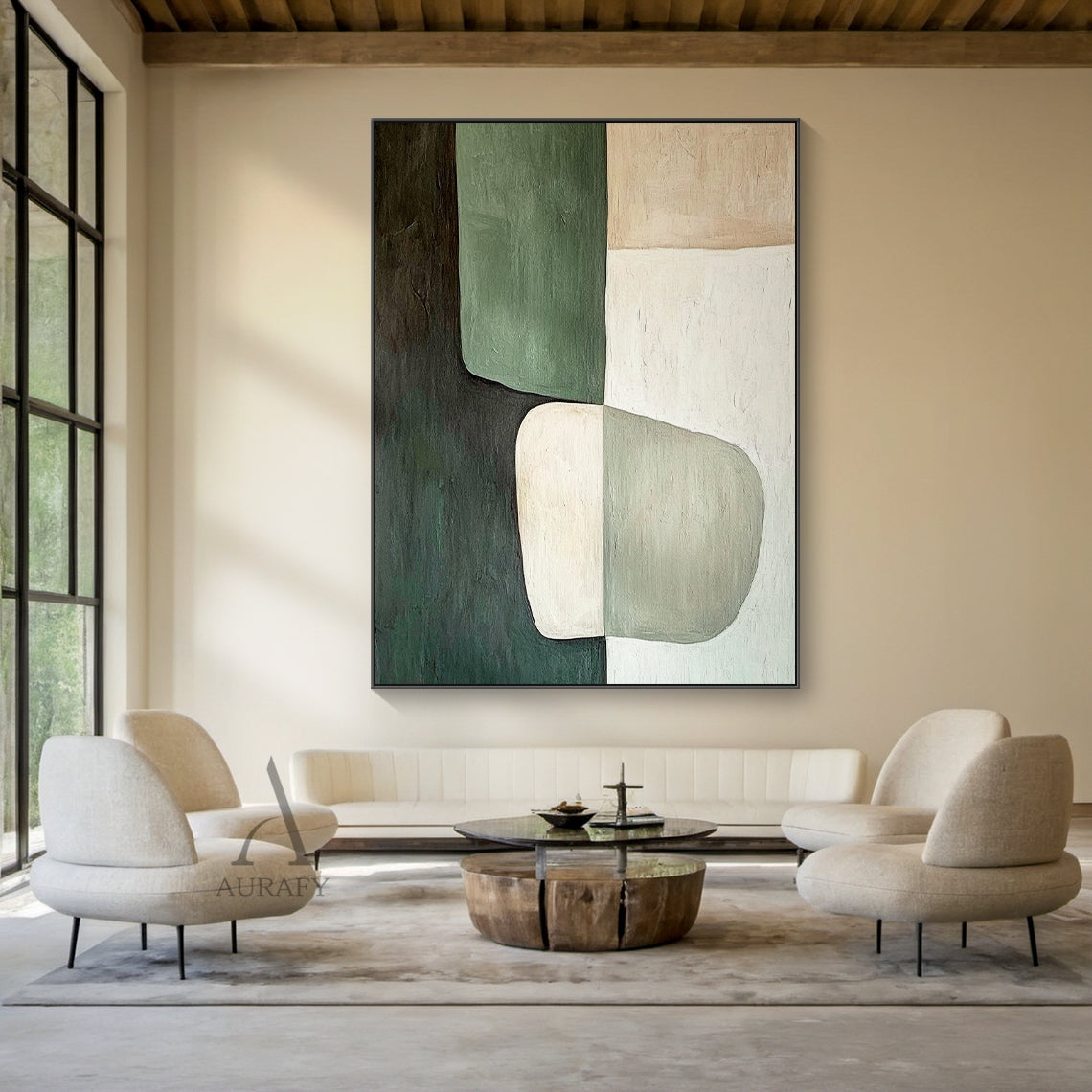 AURA405 modern organic abstract wall art, oil-acrylic blend with tactile brush stroke texture, features soft-edged muted dark green, sage green, warm beige and off-white color blocks with a two-tone irregular oval shape at lower center, displayed hung above a low-profile cream linen sofa in a sunlit wabi-sabi style living room, balanced earthy tone abstract artwork suitable for minimalist, quiet luxury, natural and Scandinavian home interior decor