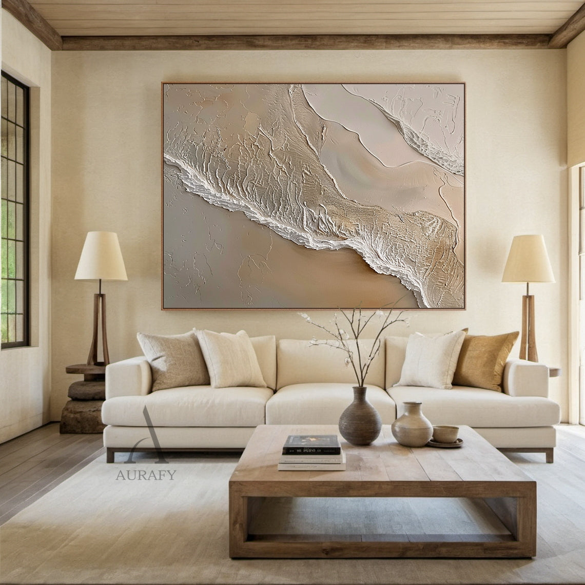 Ocean Brown Abstract Impasto Art: Tactile sculpted canvas with thick raised impasto layers of warm browns (light beige, sand tones) and wispy white lines mimicking ocean waves lapping at sunlit sand. High-relief texture creates dynamic shadows under soft ambient light. Perfect focal point for modern minimalist living room—above a sleek light gray sofa, paired with a natural wood side table and potted succulents—complementing neutral linen cushions and metallic accent decor.