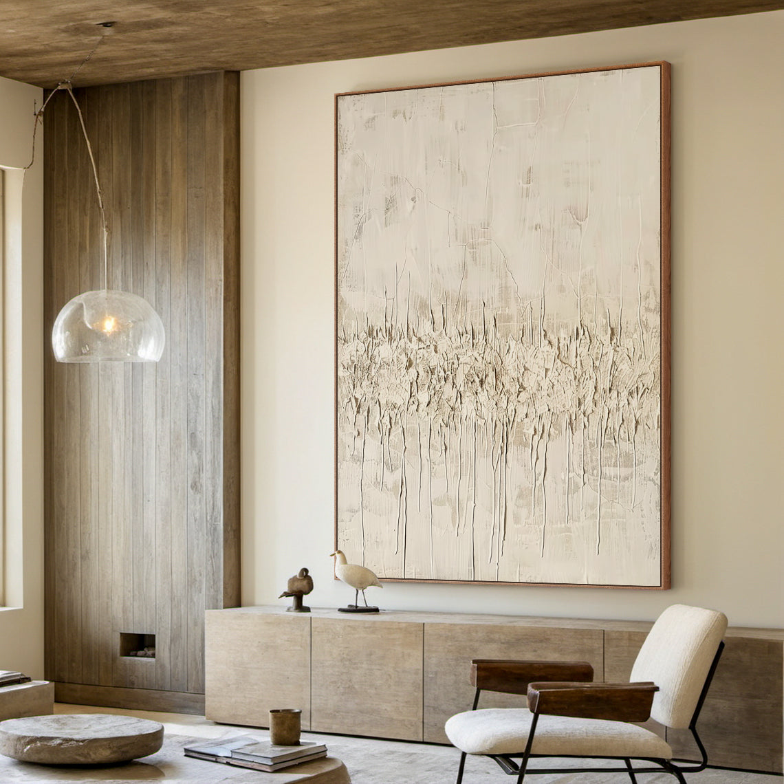 Vertical Wabi Sabi Abstract Art (AURA205) with 3D tactile plaster texture—thick impasto strokes, natural drips, and rough organic texture in neutral beige, off-white, and light brown tones. Displayed in a minimalist living room with wooden wall paneling, console table, and modern seating, embodying serene, organic Wabi Sabi aesthetics.
