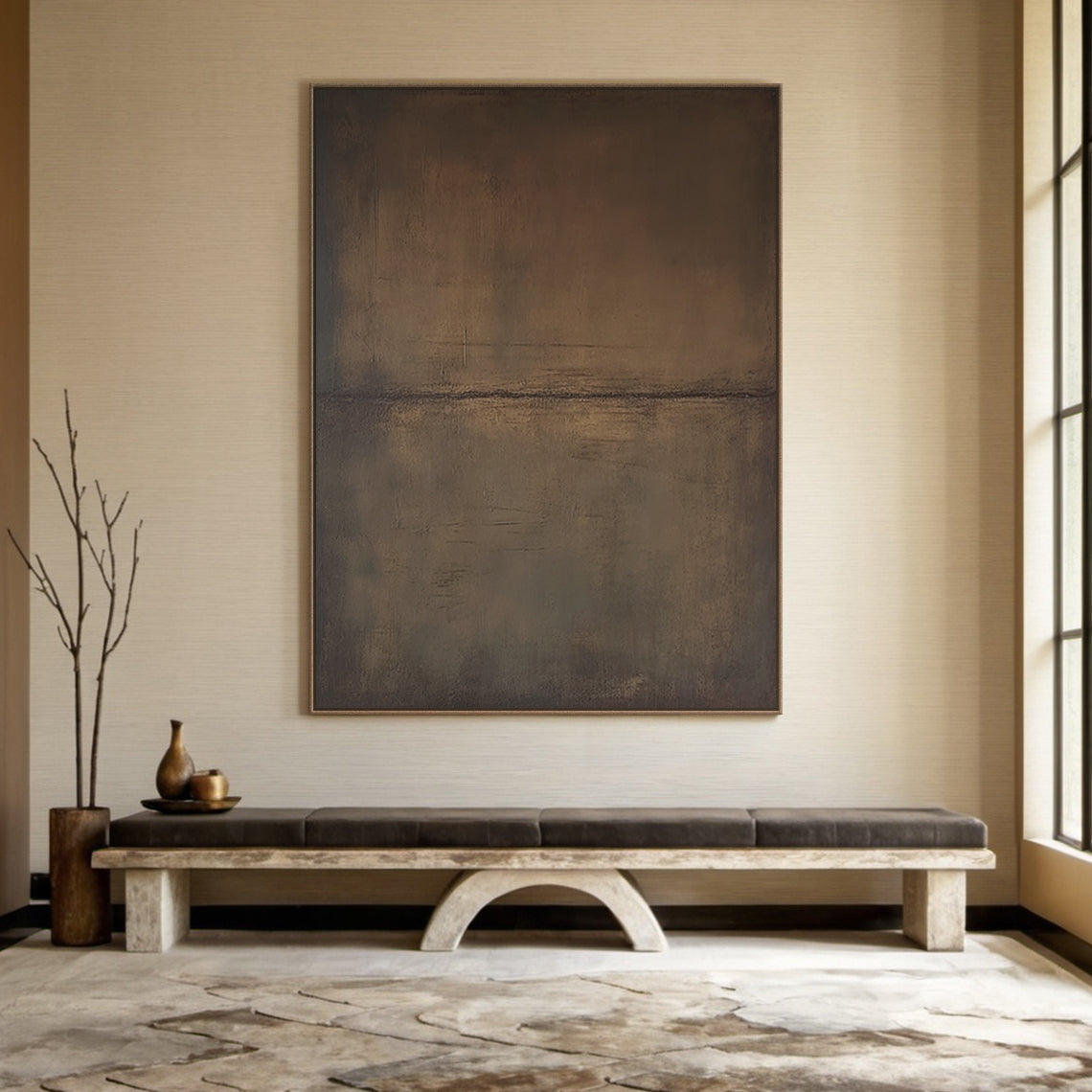Wabi Sabi Abstract Canvas Art (SKU AURA188) - Deep brown and gray-brown tones with subtle soft pink undertones, tactile mottled surface with organic brushstrokes, horizontal line composition. Hung on warm beige wall above a stone bench in a serene Japandi-style entryway, complementing natural wood decor and soft natural light. Perfect minimalist wall art for calm, organic interiors, adding a serene focal point to living spaces or bedrooms.