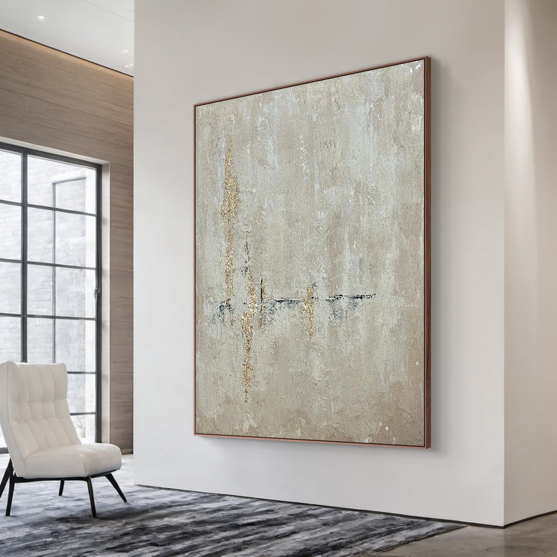 AURA226 Beige Wabi Sabi Abstract Wall Art with Gold Accents in Brown Frame - Textured muted beige base with organic hand-applied gold leaf strokes. Displayed in a sunlit living room above a sleek wooden console table, complementing neutral-toned linen sofa cushions, a potted fiddle-leaf fig, and a woven jute rug. Ideal focal point for living room, bedroom, or office minimalist/boho home decor. Captures wabi sabi’s imperfection and serene simplicity, adding understated luxury to warm, inviting living spaces.