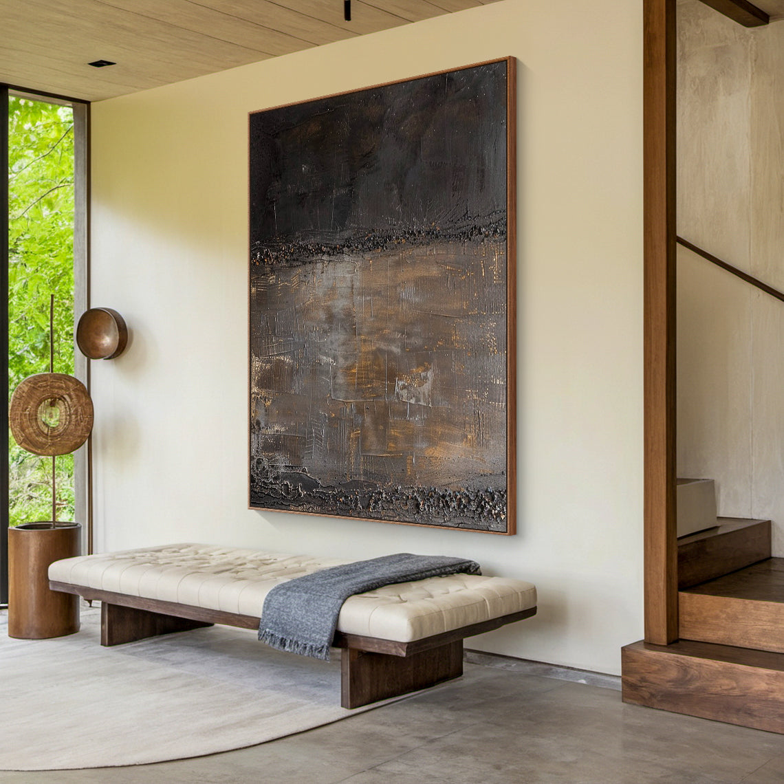 Wabi Sabi abstract art with high-relief tactile surface, bold knife strokes, and metallic foil accents in deep charcoal and warm taupe tones. Displayed in a minimalist living room (light gray linen sofa, solid wood coffee table, ceramic vase with dried branches, wool rug) — ideal for bringing a calm earthy vibe to organic Japandi living rooms, cozy neutral relaxation corners, or simple study spaces. This piece celebrates the beauty of imperfection, complementing natural materials like wood, linen, and wool