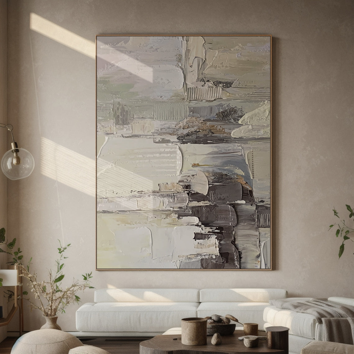 Wabi Sabi Abstract Textured Wall Art - Hand-applied impasto acrylic paint with thick, organic brushstrokes and palette knife texture. Neutral tones (beige, soft gray, off-white) with subtle pink accents, framed in natural wood. Displayed against a light gray bedroom wall, the raised texture interacts with warm lamplight—casting gentle shadows that highlight its tactile details, perfect for minimalist/bohemian/Scandinavian decor. Ideal for living room too, ready to hang with pre-installed kit.