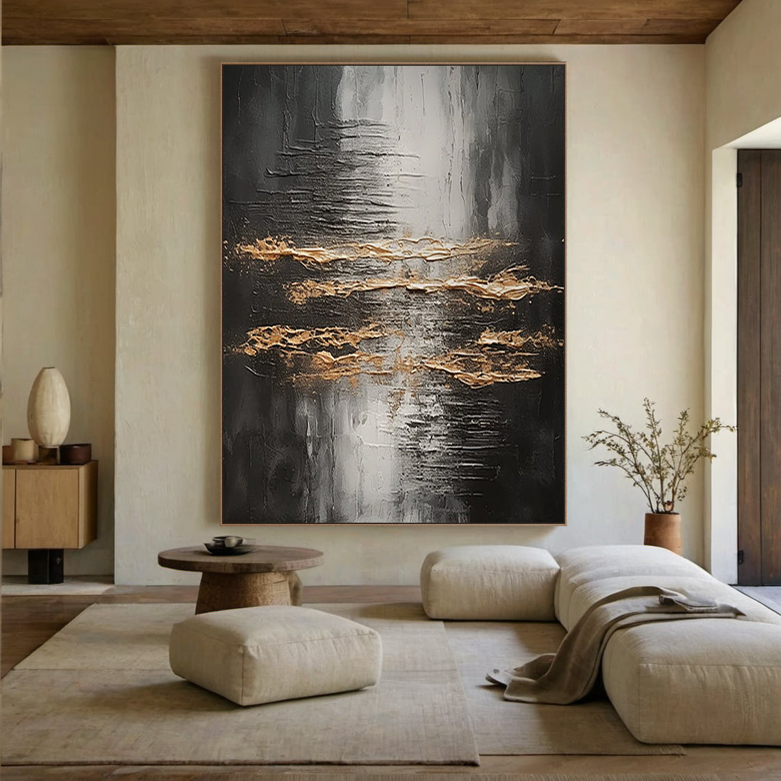Wabi Sabi Abstract Impasto Wall Art with Thick Tactile Cracked Surface - Horizontal Canvas Above Beige Sectional Sofa in Serene Japandi Living Room. Black Gray White Base with Flowing Gold Accents, Handcrafted Imperfect Texture for Minimalist or Organic Modern Decor. Aura190 Artwork Focal Point for Neutral Living Space.