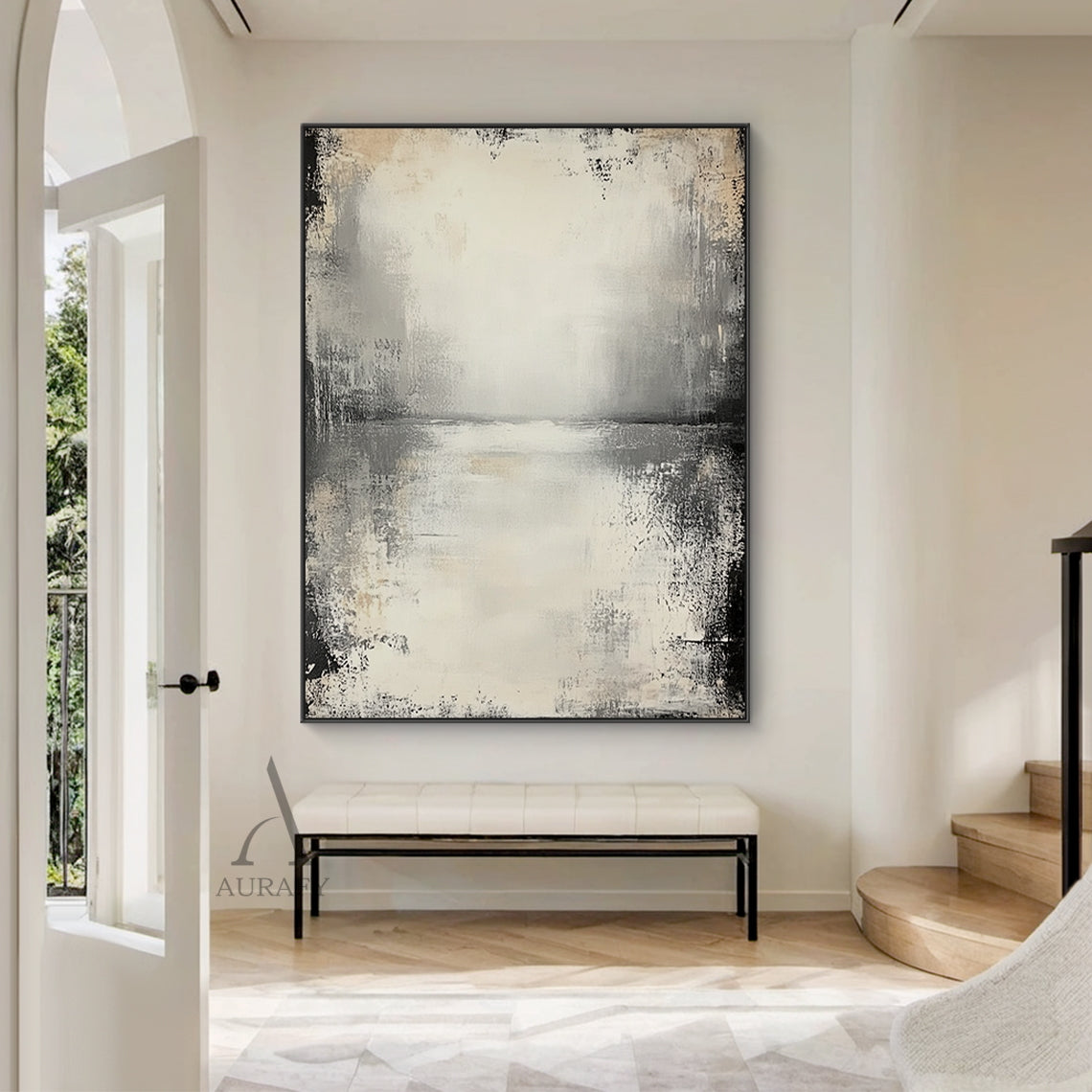 Wabi-sabi beige abstract textured canvas wall art AURA719, styled and displayed hung above a low-profile light oak sideboard in a sun-drenched minimalist Japandi living room scene, features a muted neutral color palette of off-white, pale beige, light to deep charcoal gray with faint warm brown accents, hand-finished distressed brushed & wiped texture with rough worn edges, subtle horizontal abstract sky-water horizon line across the upper middle, natural dark vignette fading from edges to the light beige b