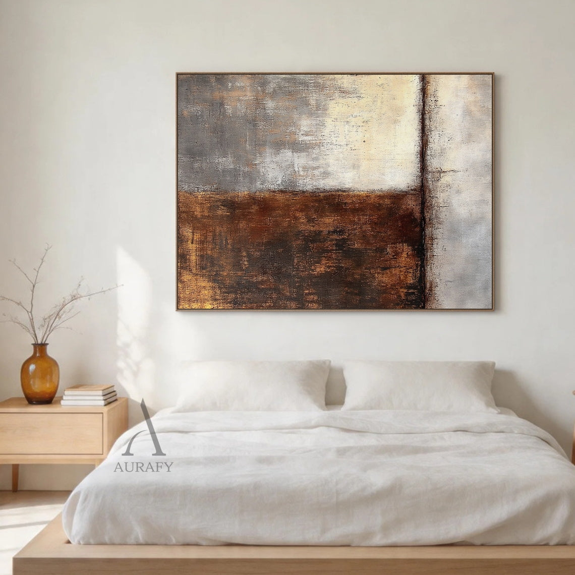 Wabi-sabi abstract wall art (AURA405) displayed above a light wood Japandi sofa with neutral linen cushions in a sunlit living room; split composition featuring warm brown and gold textured brushstrokes on the left, soft beige and gray tones on the right, matte finish, handcrafted uneven edges, and horizontal line accent—ideal for Japandi living rooms, minimalist bedrooms, bohemian entryways, or neutral-toned home office spaces.
