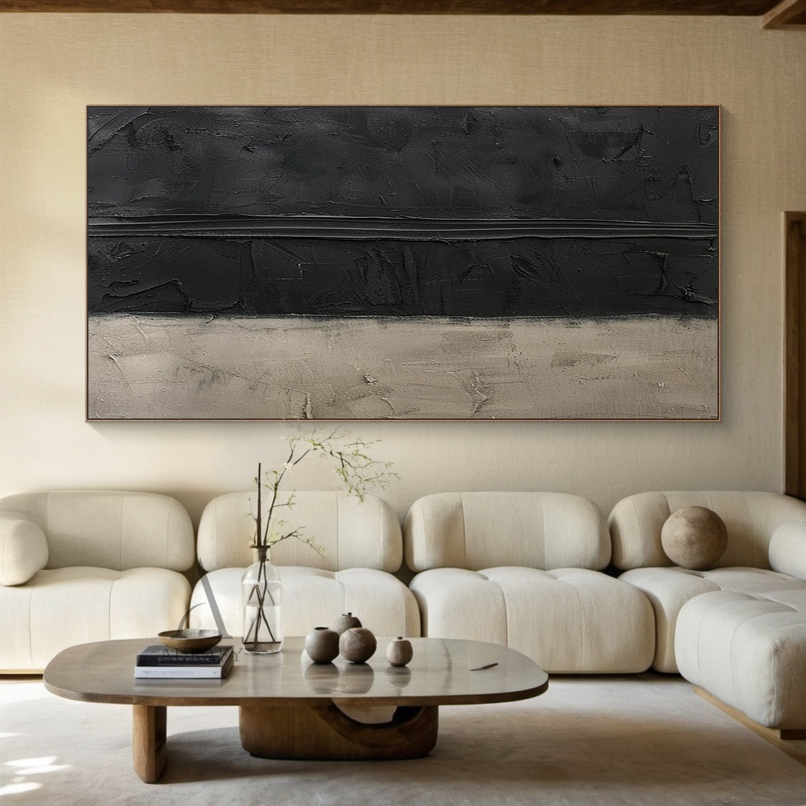 Handcrafted wabi-sabi Japandi abstract canvas artwork (AURA797), featuring a two-tone muted neutral palette of deep matte black and soft warm beige. The piece uses thick hand-applied impasto technique: upper black areas have scored, scraped pigment textures with a prominent raised horizontal impasto stripe across the middle, lower beige section has plaster-like aged, scratched, faded uneven surfaces. Minimalist textured abstract wall art for modern, minimalist, neutral industrial and Japandi home decor.