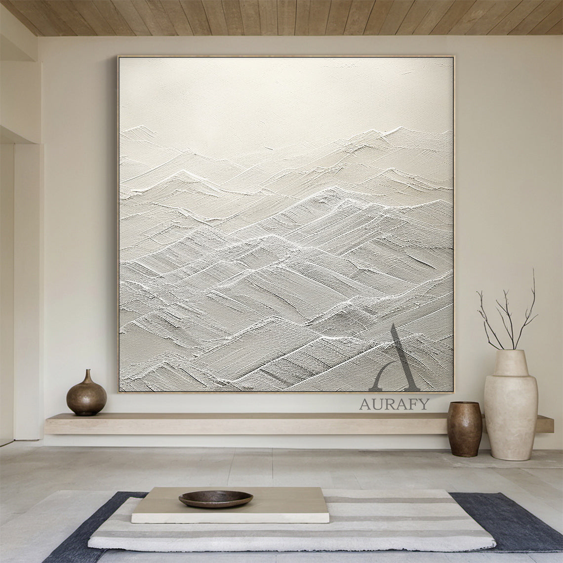 High-relief white abstract canvas art (AURA500) with thick tactile knife strokes and layered texture forming gentle peaks and valleys (evoking rolling mountains or serene waves). Monochromatic palette spanning soft ivory to crisp snow tones, merging modern minimalist style with subtle Wabi-sabi influences. Ideal focal point for Japandi spaces—perfect above a sleek wooden dining table in a sunlit eat-in kitchen, next to a woven rattan armchair in a quiet reading nook, or against a soft light gray tile wall i