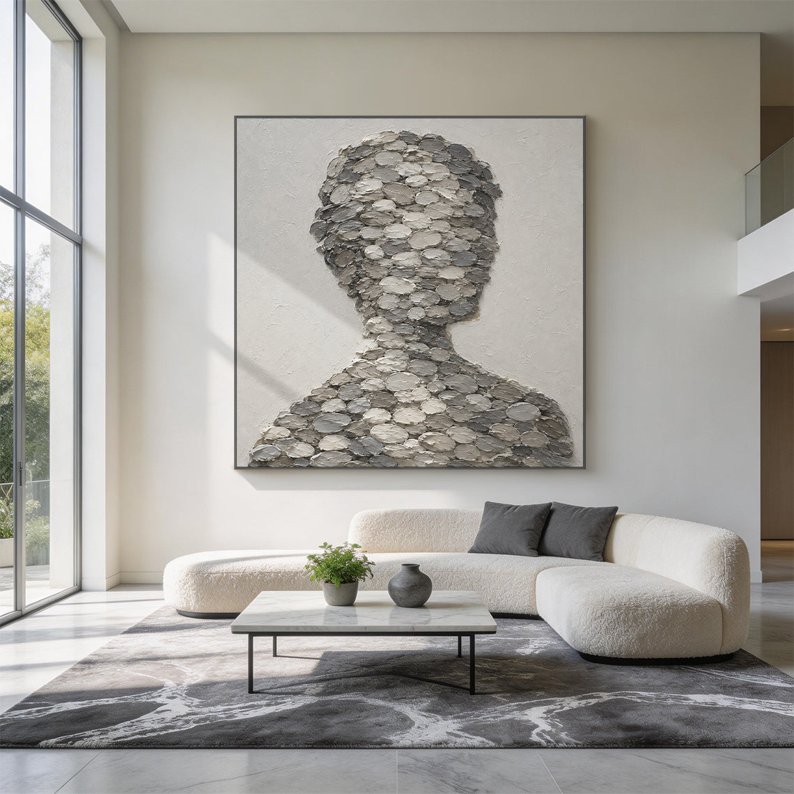 3D textured gray impasto canvas wall art AURA703, right-facing abstract human bust silhouette composed of stacked oval thick paint blobs in light, medium and dark gray tones, displayed hung on a warm matte white wall in a styled soft neutral japandi living room scene with ambient natural light, minimalist wabi-sabi abstract portrait wall decor with raised tactile finish for adding layered artistic texture to neutral interior spaces