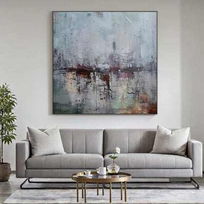 AURA229 Gray Blue Wabi Sabi Abstract Wall Art: Large Textured Canvas with Soft Gray-Blue Tones & Earthy Accents. Hanging Above Beige Linen Sofa in Minimalist Living Room, Complementing Natural Wood Coffee Table, Potted Green Plants & Warm Floor Lamp. Wabi Sabi Style Embraces Imperfection & Natural Beauty—Ideal for Living Room Wall Decor, Cozy Reading Nooks, or Bedroom Spaces. This Art Piece Adds Understated Charm to Serene Living Areas, Merging Minimalist Elegance with Rustic Warmth as Part of the AURA229 W