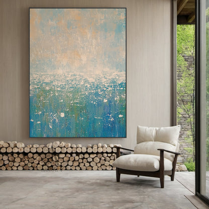 Abstract Beige Blue Impasto Artwork AURA405 Japandi Living Room Installation Display, the piece is mounted on a warm off-white accent wall above a light oak low sideboard, its soft upper gradients of pale blue and muted beige harmonize seamlessly with the surrounding neutral-toned soft furnishings and light wood decor, the lower layered blue tones ranging from bright sky blue to deep teal bring a quiet fresh coastal feeling to the space, the thick textured impasto strokes show distinct tactile layering unde