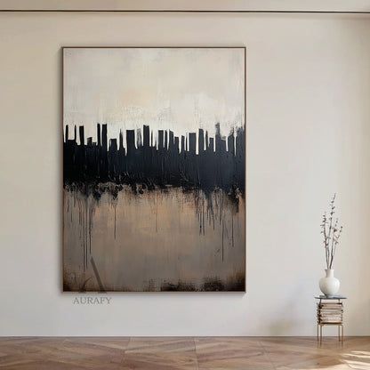 Abstract black and beige city skyline wall art styled in a cozy warm minimalist dining room interior scene, heavy impasto thick brushstrokes form bold black urban skyscraper silhouettes against a muted pale off-white gradient background, intentional black paint drips cascade over the textured warm beige lower area simulating city water reflection, tactile minimalist luxe abstract artwork hung beside a light oak dining sideboard against a soft off-white wall to show its matching effect for modern Japandi, mi