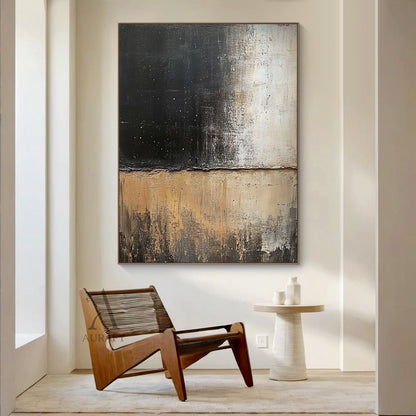 General abstract impasto canvas wall artwork AURA405, horizontally split textured composition: upper zone with thick textured deep black paint scattered with tiny white star-like specks, gradually fading to muted light beige; lower zone with layered earthy beige, warm tan and dark brown tones with vertical dragged brushstrokes evoking erosion texture, rough irregular boundary between the two sections, tactile thick paint surface, muted neutral black and beige palette fits Japandi, minimalist and neutral int