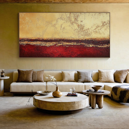 Abstract Red Yellow Textured Wall Art AURA405 (Real Living Room Sofa Background Wall Scene Display), geological stratum inspired horizontal layered abstract artwork. The top zone is light yellow-beige with cracked weathered sun-bleached texture, the middle dark band blends deep brown and maroon with uneven golden-yellow streaks, the bottom part is saturated deep red with prominent crackle textures. Wabi-sabi style tactile wall decor showing actual hanging effect above the sofa, suitable for Japandi, minimal