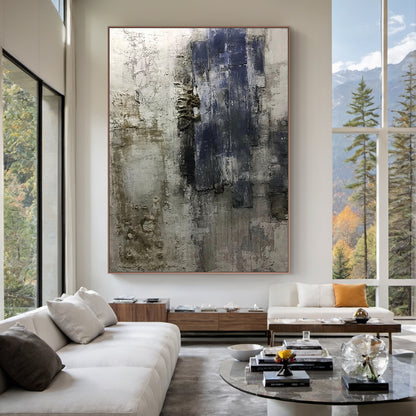 AURA223 Wabi Sabi Abstract Wall Art featuring layered impasto strokes and cracked textures in brown, black, deep blue, and neutral tones. Displayed in a cozy bedroom setting with soft linen bedding, wooden nightstand, warm-glow table lamp, potted succulent, and neutral curtains—perfect for living room, bedroom, or office decor. Embodies the Wabi Sabi philosophy of finding beauty in imperfection, adding depth to minimalist, rustic, or modern spaces. Its tactile organic finish serves as a captivating focal po