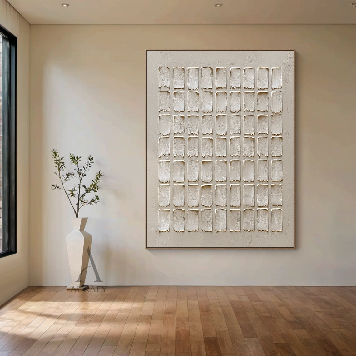 Beige Abstract High-Relief Plaster Wall Art: 7x9 Grid of Hand-Applied Textured Squares with Irregular Edges. Tactile Minimalist Decor Perfect for Above a Light Linen Sofa in a Nordic Living Room, Beside a Slender Floor Lamp in a Japanese Minimalist Tea Room, or Against a Warm Wood Paneled Wall in a Contemporary Dining Area. Warm Muted Beige Tones (Soft Cream, Warm Sand) with Organic Imperfection & Wabi-Sabi Influence.