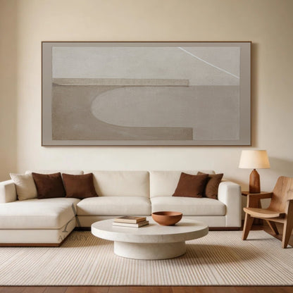 Beige Wabi-Sabi Abstract Textured Japandi Canvas Wall Art AURA731 Living Room Real Scene Display, with gritty grainy matte beige base, two soft-edged hazy light taupe horizontal rectangles placed on the upper area and lower left area, a blurred semi-circular light beige curved shape between the two rectangles, one thin crisp bright white diagonal line at the top right corner, shown hung above a low-profile light beige linen sofa on a warm off-white accent wall in a sunlit Japandi living room as styling refe