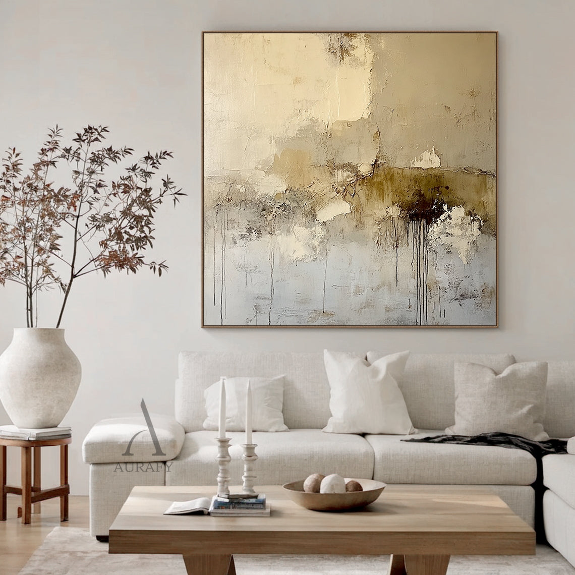 Beige abstract textured canvas wall art AURA405 [real home scene display], with the original neutral palette including off-white, light beige, warm taupe and tiny deep brown accents. All characteristic textured details are fully presented: scratch marks on light beige areas, pigment stacking & peeling edges, vertical dark brown paint drips on lower right. No figurative elements, wabi-sabi japandi style, shown hung on the wall of a minimalist organic home space, which can intuitively display the actual decor