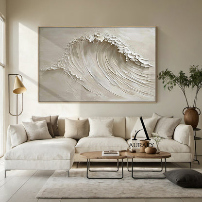 AURAFY beige monochrome high relief impasto canvas wall art mounted on a warm oak accent wall in a sunlit Japandi style bedroom, handcrafted with thick sculpted plaster/heavy acrylic texture to present a vivid rolling cresting sea wave. Multi-layered raised strokes form the soft flowing curve of the wave body, ragged uneven raised edges at the top simulate the foamy splashing of breaking surf, paired with a smooth matte warm beige background. The 3D textured surface produces natural varied light and shadow 