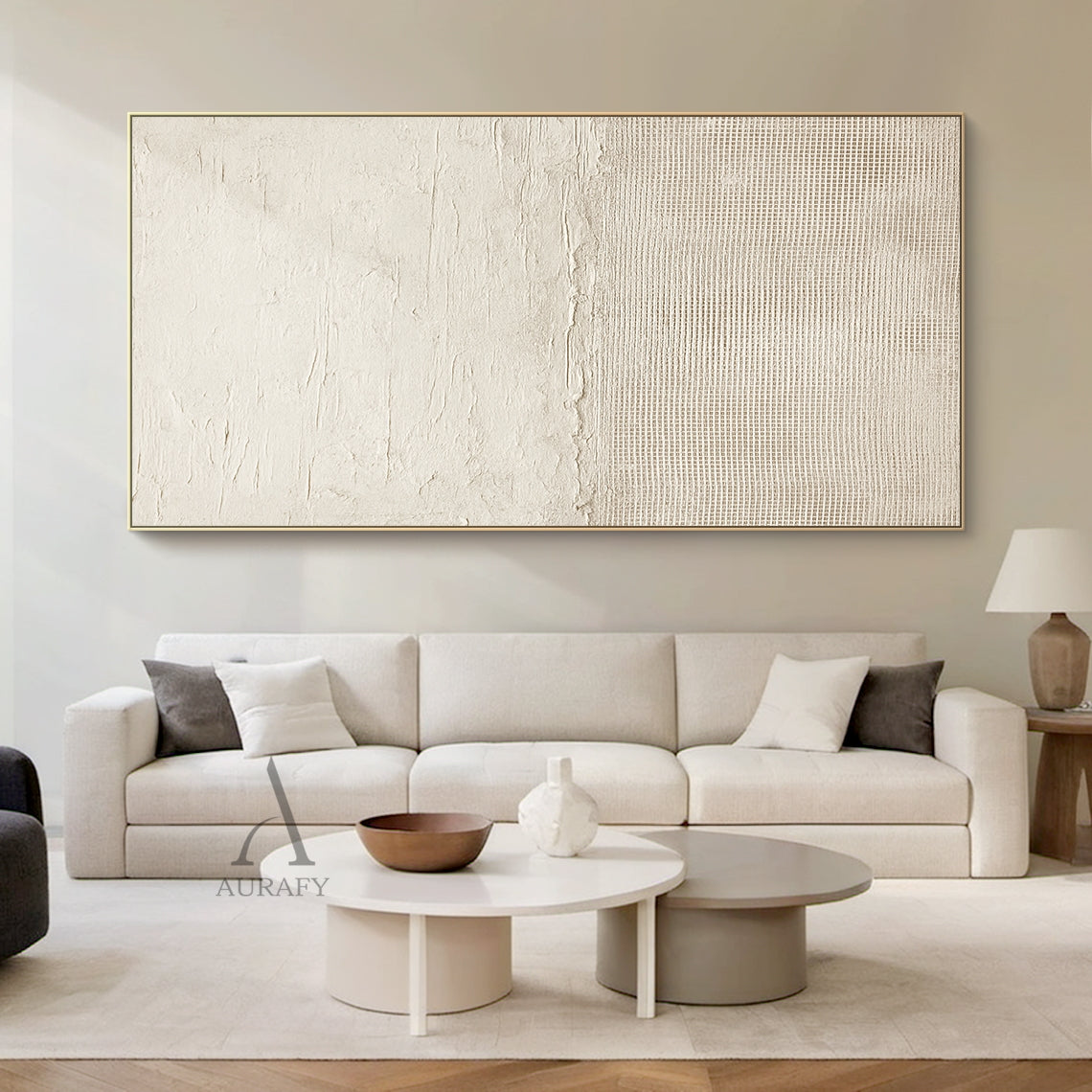 Beige general abstract wabi-sabi wall art hung in real Japandi minimalist home living space scene, upper part features light creamy off-white thick impasto plaster-like rough horizontal textured finish with subtle organic imperfections, lower part comes with slightly deeper warm beige fine linen grid woven texture, connected by a raw uneven handcrafted torn-edge seam, monochromatic neutral tactile canvas artwork displayed against light oak backdrop as decor effect reference, SKU AURA722