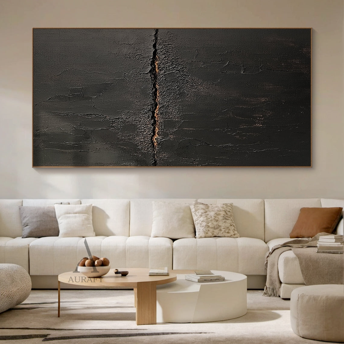Black abstract textured impasto canvas wall art AURA723 hung above low-profile dark linen sofa in moody modern living room, deep matte black surface with heavy crackle texture resembling aged cracked lacquer or charred earth, a rough horizontal split runs across the center of the piece with subtle warm earthy gold underlayer exposed, fine organic fissures spread out from the split, raw wabi-sabi tactile artwork perfect for elevating dark minimalist, japandi and contemporary interior decor