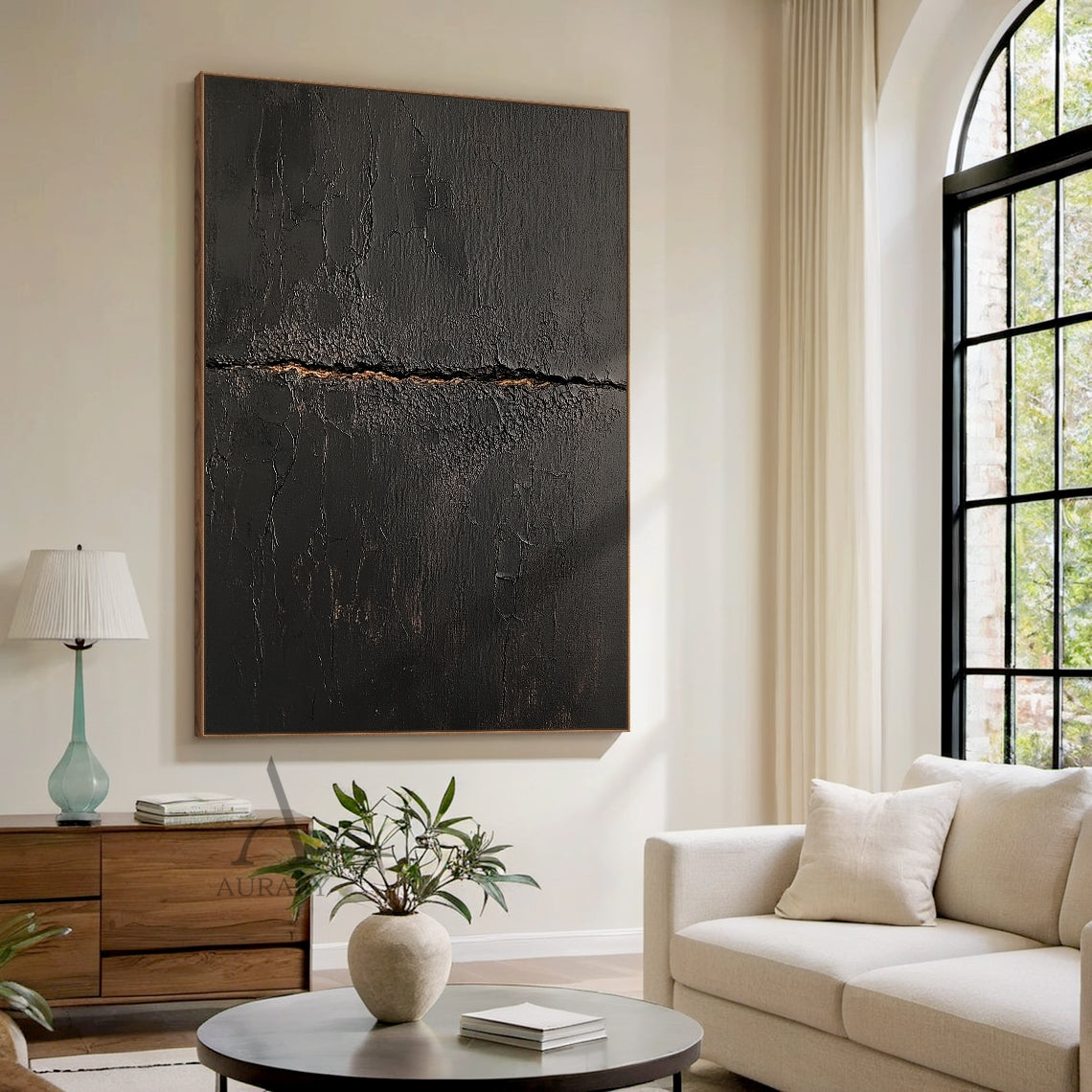 Black abstract textured impasto canvas wall art AURA723 hung above light oak low console table in sunlit warm japandi entryway, deep matte black surface with heavy crackle texture resembling aged cracked lacquer or charred earth, a rough horizontal split runs across the center of the piece with subtle warm earthy gold underlayer exposed, fine organic fissures spread out from the split, raw wabi-sabi tactile artwork perfect for adding textural contrast to light minimalist, japandi and warm contemporary inter