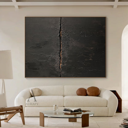 Black general abstract textured impasto canvas wall art AURA723, deep matte black surface with heavy crackle texture resembling aged cracked lacquer or charred earth, a rough horizontal split runs across the center of the piece with subtle warm earthy gold underlayer exposed, fine organic fissures spread out from the split, raw wabi-sabi tactile artwork for moody modern interior decor