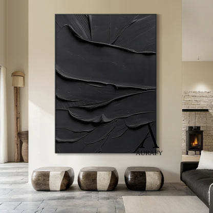Black minimalist textured abstract wall art, featuring thick impasto knife-scraped matte black paint strokes with natural flowing undulations, raised ridges and subtle brush marks. All light and shadow variations come from the dimensional texture's light reflection difference, no extra pigments are added, with a tiny AURAFY brand logo at the bottom right corner, suitable for wabi-sabi, Japandi, modern industrial interior decor.