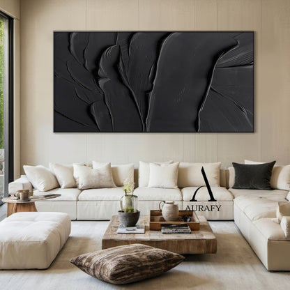 Black minimalist textured abstract wall art, featuring thick impasto knife-scraped matte black paint strokes with natural flowing undulations, raised ridges and subtle brush marks. All light and shadow variations come from the dimensional texture's light reflection difference, no extra pigments are added, with a tiny AURAFY brand logo at the bottom right corner, suitable for wabi-sabi, Japandi, modern industrial interior decor.