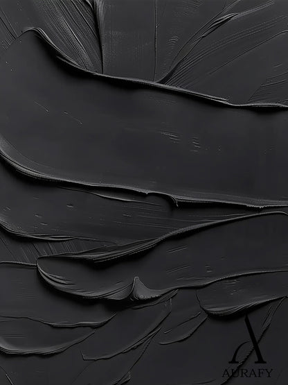 Black minimalist textured abstract wall art, featuring thick impasto knife-scraped matte black paint strokes with natural flowing undulations, raised ridges and subtle brush marks. All light and shadow variations come from the dimensional texture's light reflection difference, no extra pigments are added, with a tiny AURAFY brand logo at the bottom right corner, suitable for wabi-sabi, Japandi, modern industrial interior decor.