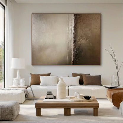 AURA649 General Abstract Brown Artwork, real residential scene display of the modern organic sculpted canvas wall piece mounted on interior wall. Non-representational abstract art with monochromatic earthy brown palette ranging from deep chocolate, warm taupe, soft beige to muted gray-brown, features 3D sculpted impasto layers with subtle cracked details, soft tonal transitions create diffused light effect and depth, perfectly integrates with Japandi, minimalist, wabi-sabi home decoration styles, adding a w