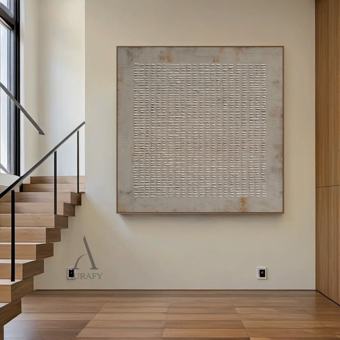 Styled interior scene shot of abstract gray high-relief impasto grid wall art AURA405, handcrafted raised off-white irregular woven-style grid strokes on muted textured gray background with subtle rust brown weathered accents at edges. This textural minimalist industrial wabi-sabi artwork is presented mounted on a soft neutral wall, suitable for Japandi, neutral modern home and office space decor.