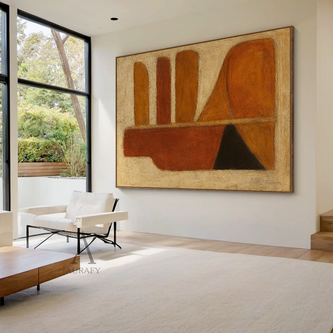 Handcrafted abstract brown wall art with tactile brushstroke texture and organic geometric composition, styled in a bright open-concept home dining space. The piece retains its signature design: left side with a vertical deep rust red-brown bottle-shaped silhouette, matched with black and orange-brown triangular blocks at the base, right side with rounded horizontal strips in warm amber, rust and brown tones plus curved orange-brown blocks, all set against a muted off-white textured background. This warm mi
