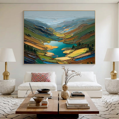 Green impasto semi-abstract landscape oil painting handcrafted with palette knife thick strokes, depicting rolling alpine foothill stream scenery: hazy mist-wreathed rolling distant ridges in light blue and muted gray at the top, vibrant teal winding mountain stream as the core visual focal point in the center, sloped sides dotted with multi-toned green coniferous forests, soft lime green wild meadows, taupe bare rock slopes and warm golden sunlit shrub patches. Thick pigment stacking creates rich tactile t