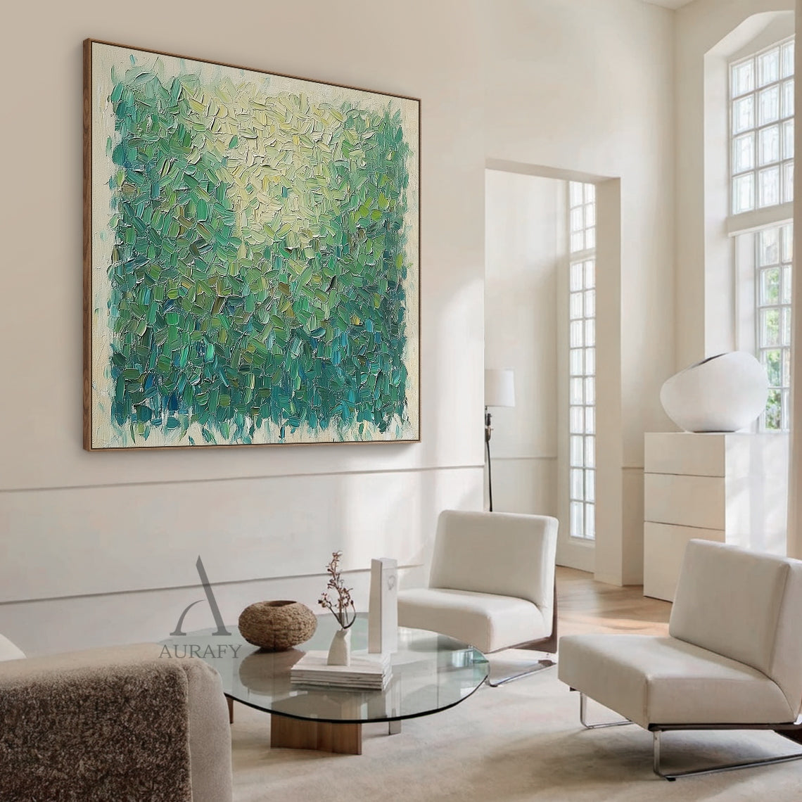 Semi-abstract impressionist green landscape impasto canvas painting, handcrafted with thick palette knife short textured strokes. The upper part features pale yellow and soft green tones mimicking sunlit leaf surfaces, with a natural gradient shifting to grass green, olive green and dark teal green on the lower section to present the rich layered texture of shaded foliage, surrounded by a light beige raw canvas border at the edge. This minimalist decorative wall art perfectly suits Japandi, Scandinavian, mo