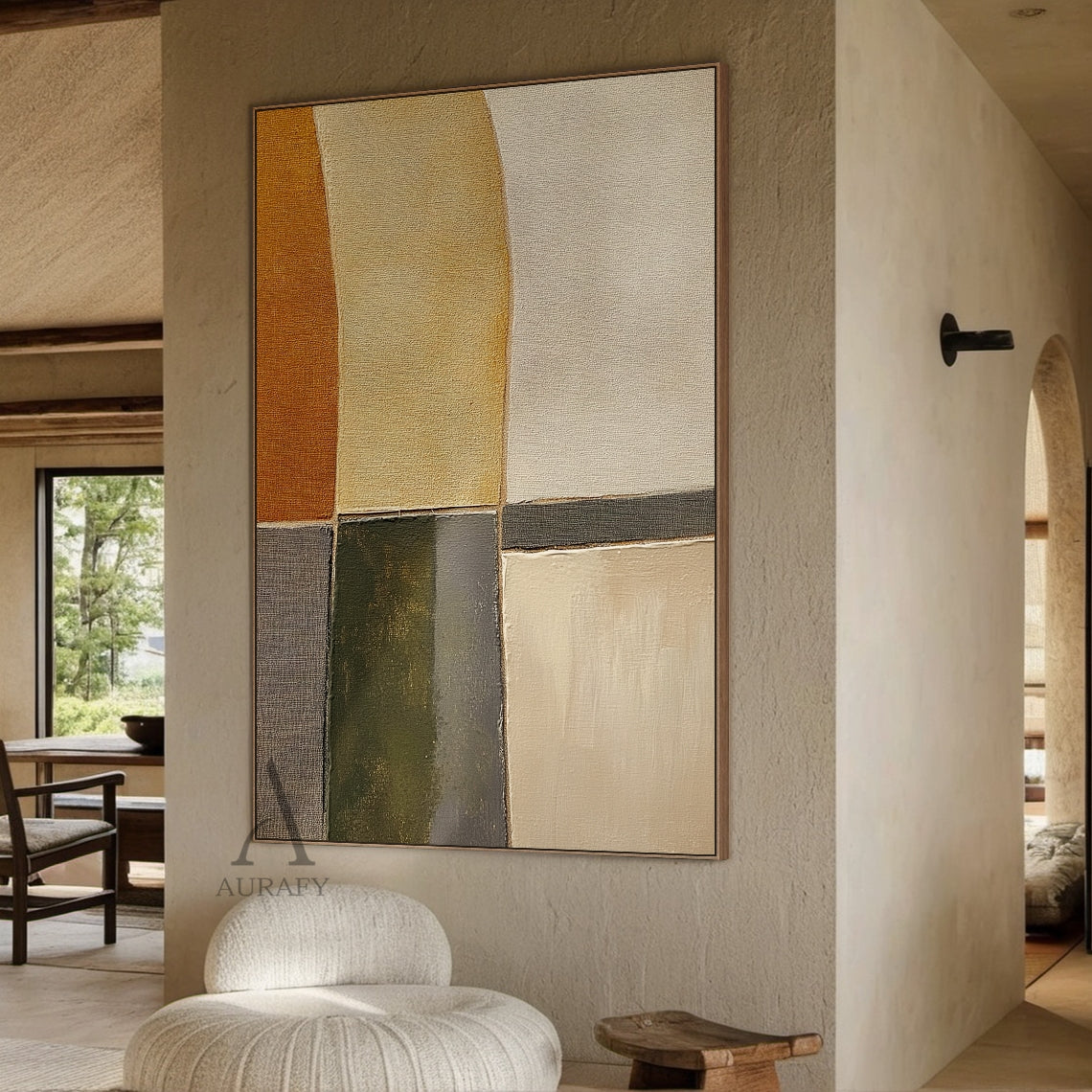 Scene display shot of AURA405 hand-painted brown geometric abstract canvas wall art, shown installed on a matte white interior wall above a low-profile solid wood console as an entryway decorative accent, features patchwork of curved and angular geometric color blocks in warm burnt sienna, soft sand beige, olive green, charcoal gray and off-white earthy tones. Visible thick impasto brush stroke texture and canvas grain, edges of color blocks have both sharp division lines and soft blurred transitions, the w