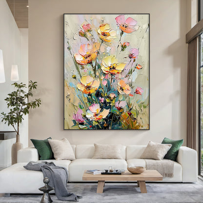 Impasto palette knife oil painting of wild clustered floral landscape, featuring fully bloomed, half-opened and budding flowers in soft buttery yellow, blush pink, light peach shades, paired with muted sage green stems and foliage, set against a neutral creamy beige textured background. Thick raised paint strokes form obvious tactile hand-painted texture, in impressionist wabi-sabi decorative style, designed for modern organic home wall decoration.