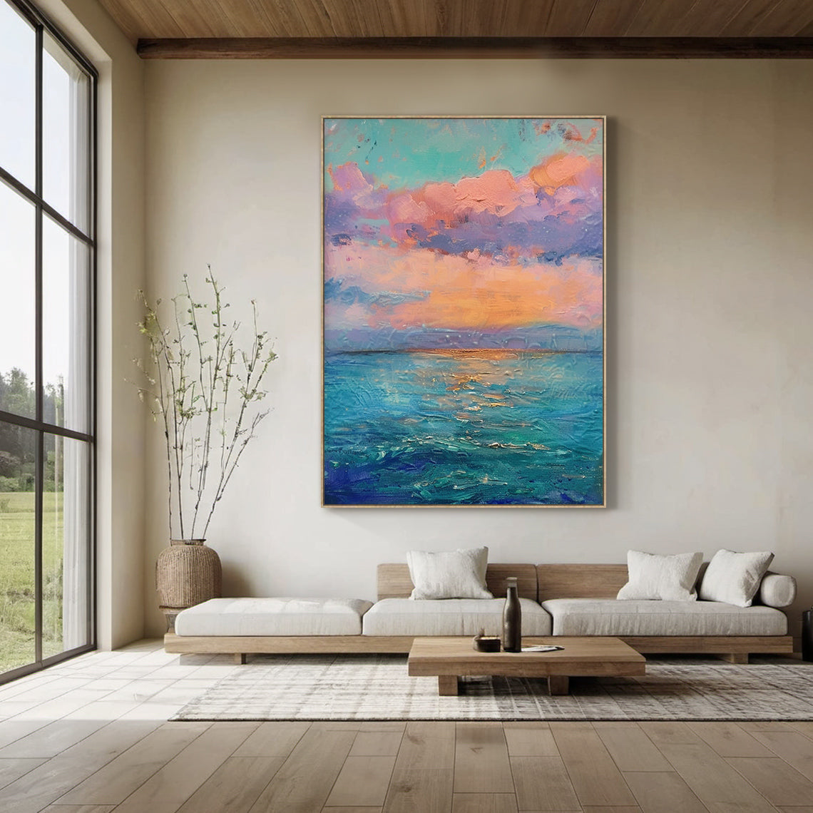 Impressionist thick impasto coastal sunset vertical canvas wall art, hanging display on light warm gray wall above solid wood dining table with white ceramic tableware and small green plant centerpiece, soft pink, peach, lavender gradient clouds under pale turquoise sky, warm orange sunset glow above layered indigo, teal, light blue ocean with golden light reflections, textured palette knife strokes, dreamy pink blue landscape painting for living room bedroom dining room modern home decor AURA712