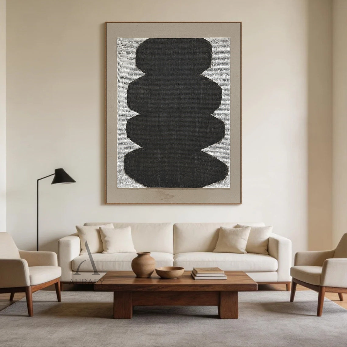 Minimalist abstract Japandi wabi-sabi wall artwork AURA727 staged in a calm curated modern living room, square raw woven canvas with clear grid texture is mounted on off-white plaster wall above a low light oak sideboard, features stacked soft curved matte black organic form with no sharp edges, uses monochrome black, white and neutral gray color palette, canvas weave texture is visible through both painted and unpainted areas, paired with a light taupe matte border, styled alongside neutral linen soft furn