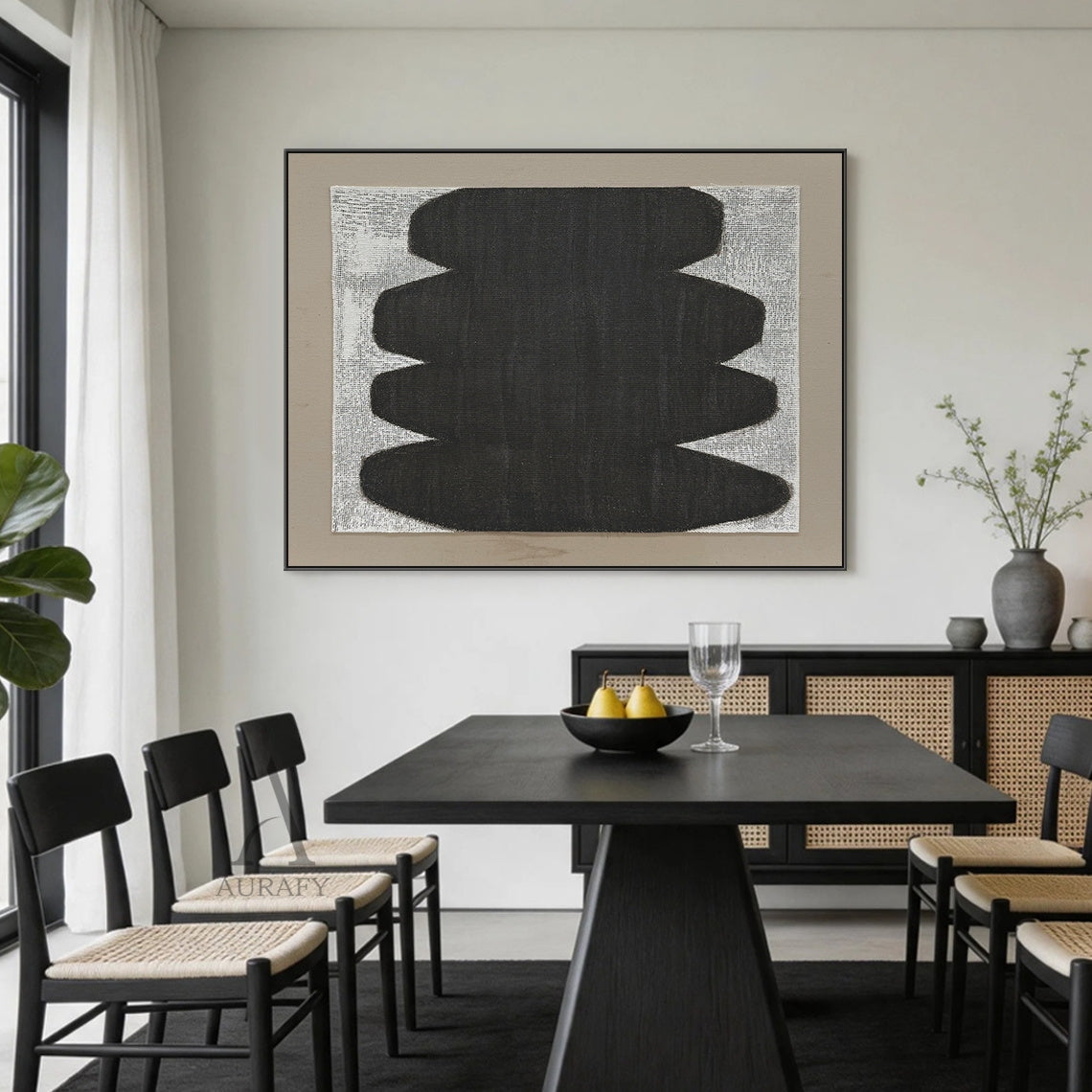 Minimalist abstract Japandi wabi-sabi wall artwork AURA727 staged in a calm curated modern living room, square raw woven canvas with clear grid texture is mounted on off-white plaster wall above a low light oak sideboard, features stacked soft curved matte black organic form with no sharp edges, uses monochrome black, white and neutral gray color palette, canvas weave texture is visible through both painted and unpainted areas, paired with a light taupe matte border, styled alongside neutral linen soft furn