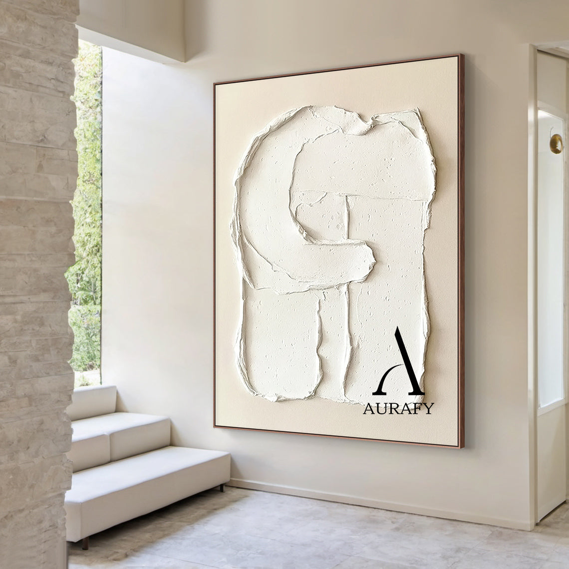 Aurafy AURA541 minimalist plaster textured wall art, warm soft beige canvas base with hand-applied thick impasto matte white 3D abstract capital letter G shape, with irregular handcrafted rough edges, natural porous surface details and texture folds, real shot hung on off-white matte living room accent wall, with light gray linen sofa and small teak side table in the background, neutral tone wabi sabi japandi wall decor for modern minimalist, Scandinavian and cozy neutral home.